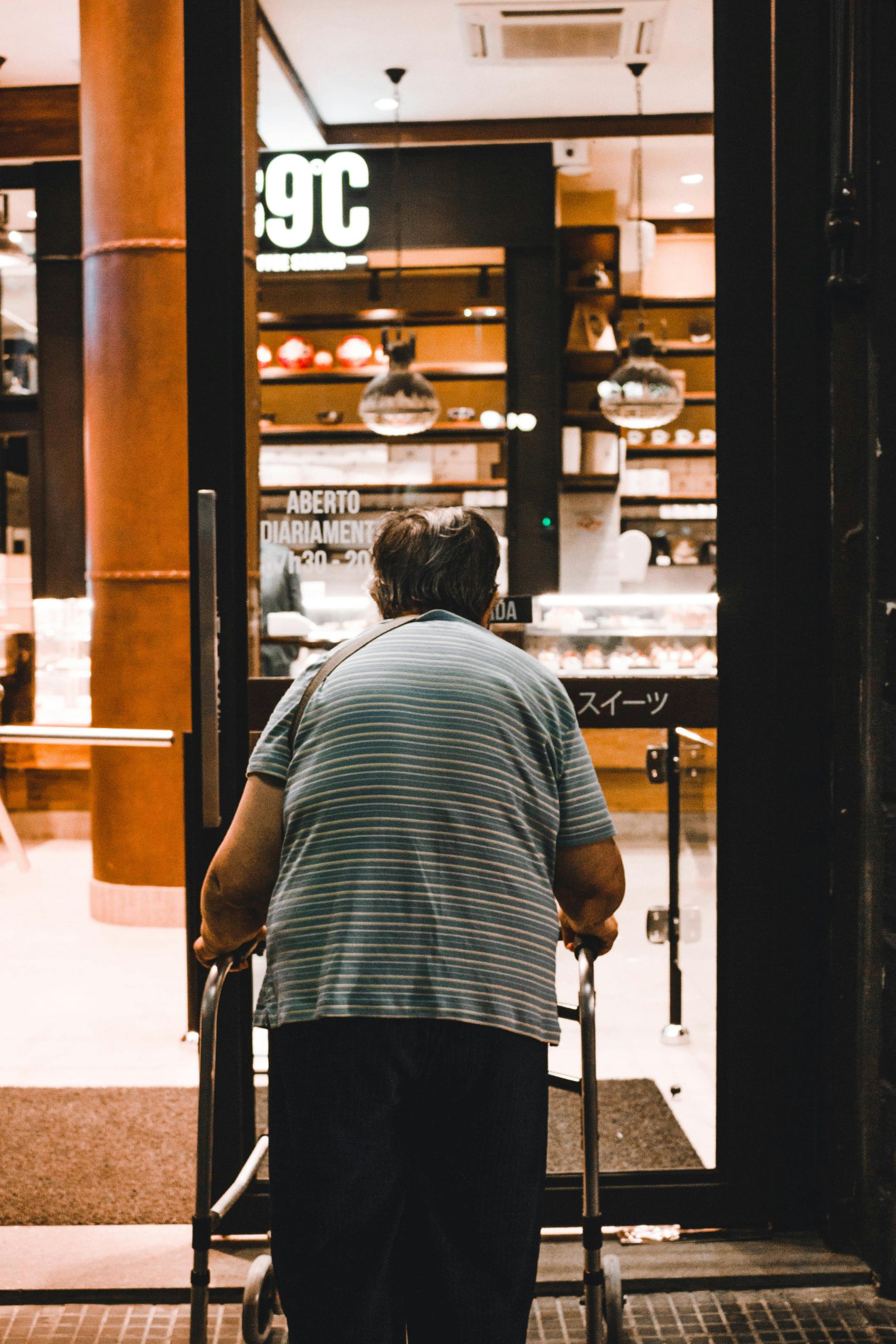 An elderly man is using a Rollator walker